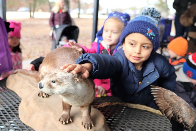 Children participating in the USO Wisconsin’s Hike and Hunt event Nov. 17, 2021, at Fort McCoy, Wis., look at taxidermy mounts that relate to animals of Wisconsin. The items were brought to the event by Natural Resources Specialist Kevin Luepke...