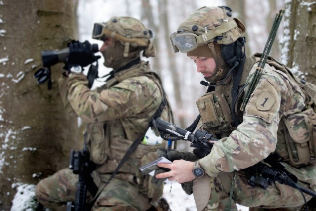U.S. Army Pfc. Kyle Lavorante (left) and Spc. Jakeb Tadlock, Joint Fire Support Specialists with Bravo Company, 1st Battalion, 16th Infantry Regiment, 1st Armored Brigade Combat Team, 1st Infantry Division, observe and report in via radio as part...
