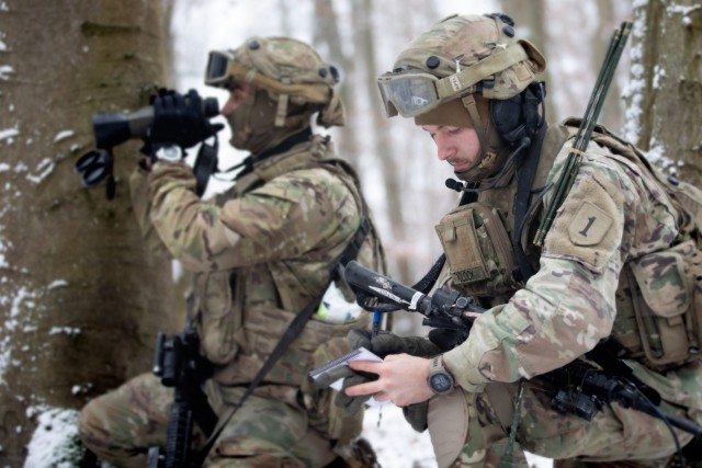 U.S. Army Pfc. Kyle Lavorante (left) and Spc. Jakeb Tadlock, Joint Fire Support Specialists with Bravo Company, 1st Battalion, 16th Infantry Regiment, 1st Armored Brigade Combat Team, 1st Infantry Division, observe and report in via radio as part of a COLT (Combat Observation Lasing Team) for Combined Resolve XVI at the Joint Military Readiness Center in Hohenfels, Germany, Dec. 2, 2021. The teams are part of the force-on-force exercise portion of Combined Resolve XVI, which includes approximately 4,600 armed forces service members from Bulgaria, Georgia, Greece, Italy, Lithuania, Poland, Serbia, Slovakia, Slovenia, Ukraine, United Kingdom and the United States. The operations are being conducted by integrated battalions with multinational units operating under a unified command and control element, allowing the U.S., its allies and partners to experience invaluable training alongside each other. 