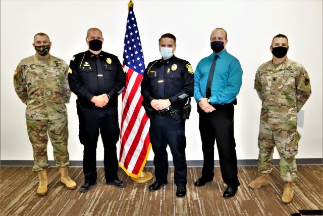 Lt. Benjamin Finn and Sgt. Kevin Eckelberg with the Fort McCoy (Wis.) Directorate of Emergency Services Police Department are recognized Dec. 2, 2021, by Garrison Commander Col. Michael Poss as part of the Garrison Command Team who presented the...