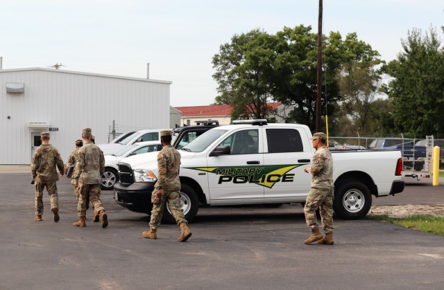 Military police assigned to work with the Fort McCoy Garrison Directorate of Emergency Services (DES) Police Department head to a meeting place Sept. 2, 2021, at Fort McCoy, Wis. DES augmented its police force with the 411th Military Police...