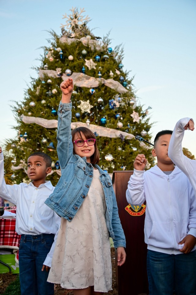 Students from C.C. Pinckney Elementary School choir sing holiday carols before the tree is light during the Holiday Tree Lighting Ceremony. More than 200 Soldiers, veterans, civilians and their Family members attended the Dec. 3, 2021, ceremony...