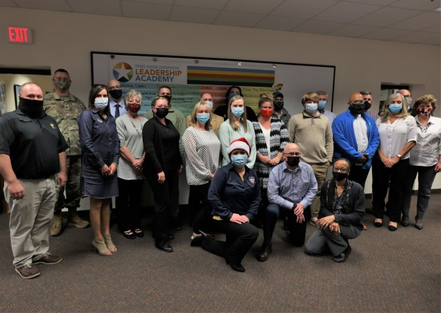 The graduating class of Fort Knox’s fall Garrison Leadership Academy pose with Fort Knox Garrison leaders Dec. 9, 2021.