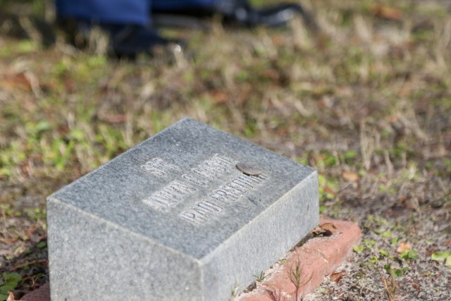 A stone at the foot of a crape myrtle in the Warriors Walk on Fort Stewart, Georgia, marks the tree planted in tribute to Sgt. 1st Class Alwyn Cashe, Dec. 19, 2020. Cashe attempted the rescue of seven Soldiers and an Iraqi interpreter from a burning Bradley Fighting Vehicle in Oct. 2005 and posthumously received the Silver Star Medal for his actions that ultimately took his life. The coin left there by a visitor ensures the fallen Soldier’s family knows that someone stopped to pay respects, with the quarter likely indicating that the visitor was present when the Soldier died.