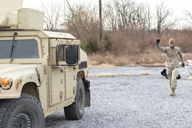 A Soldier with the 1st Area Medical Laboratory gudies a humvee Dec. 7 while supporitng a command post exercise led by the 20th CBRNE Command at Fort Indiantown Gap, Pennsylvania. The exercise was one step along the path to Global Defender 22, a...