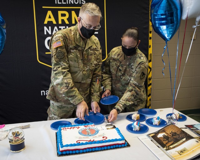 Maj. David Tanner (left), National Guard liaison officer, U.S. Army sustainment Command, and Col. Aracelis Perez, senior National Guard advisor, ASC, cut the National Guard birthday cake at Rock Island Arsenal, Illinois, Dec. 13. The heritage of...