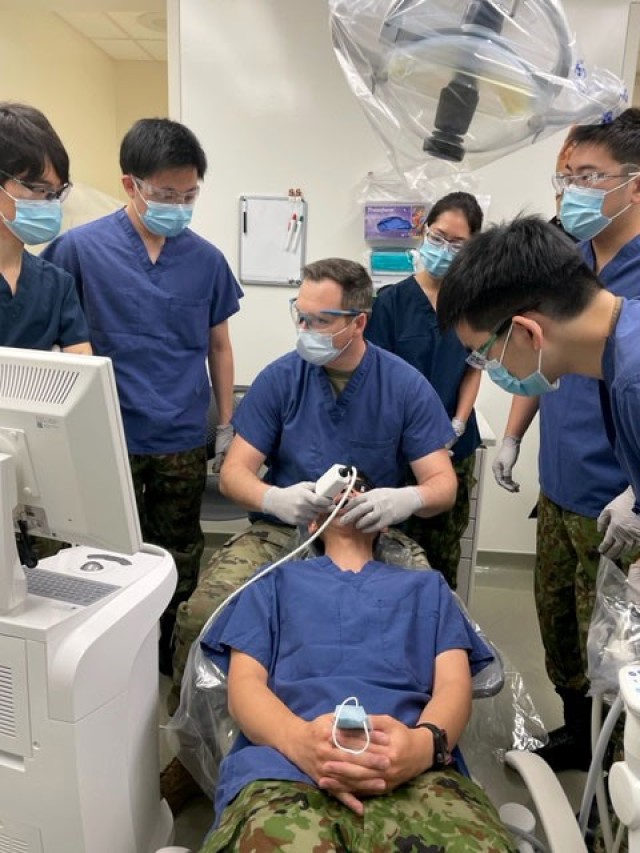 A U.S. Army dentist demonstrates technology and equipment for his Japan Ground Self-Defense colleagues during joint training at Camp Zama, Japan. 