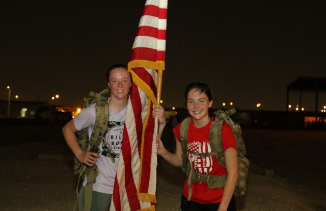 Sgt. Mariah Robinson, left, and Spc. Morgan Miller, pose for a picture with an American flag after a nighttime ruck march in commemoration of Veterans Day Nov. 11, 2021, at Camp As Sayliyah, Qatar. 

Robinson and Miller are University of Nebraska students and members of the Nebraska Army National Guard’s 734th Combat Sustainment Support Battalion, currently deployed to assist with the Afghan Evacuations Mission Support Element.
