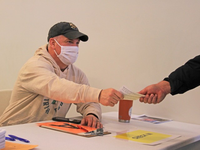 Scott Zelenock, Detroit Arsenal Garrison Directorate of Operations, hands out a COVID-19 test documentation form at the arsenal’s walk-in COVID-19 test center.  The center opened the first week in December.
