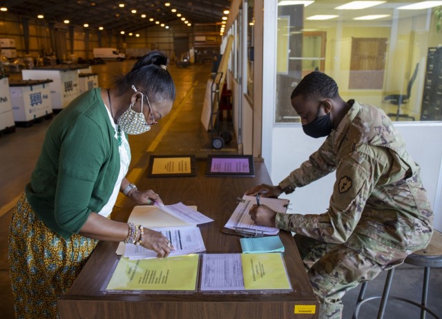 402nd Army Field Support Battalion-Hawaii's property book officer Reese Fontenot reviews the paperwork from a unit turning in excess equipment at the  Modernization, Displacement, and Repair Site. When a unit has equipment that no longer aligns...