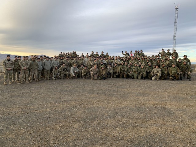 Soldiers assigned 2nd Stryker Brigade Combat Team, 7th Infantry Division and members of the Japanese Ground Self-Defense Force pose for a photo during training exercise Rising Thunder on December 10, 2021 at Yakima Training Center, Wa.