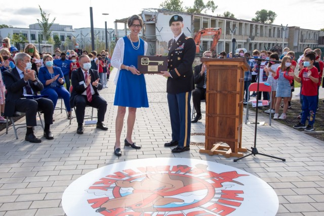 Col. Patrick Dagon, commander of the U.S. Army Corps of Engineers Europe District presents a key plaque to Sue Morin, principal of Wiesbaden Elementary School during the ribbon cutting ceremony at the new Wiesbaden Elementary School in Wiesbaden,...