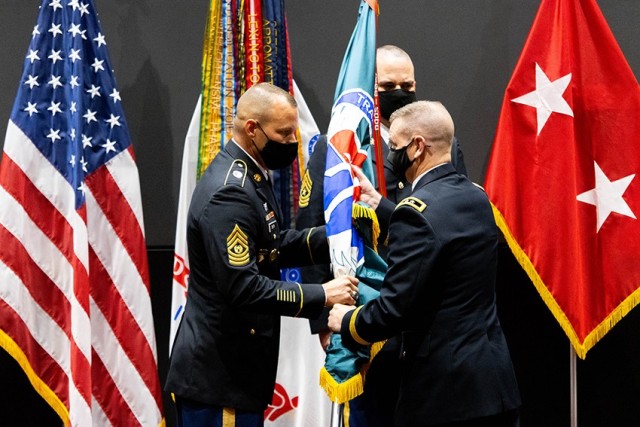 Incoming U.S. Army Aviation and Missile Command Command Sgt. Maj. Bradford Smith receives the unit colors from AMCOM Commander Maj. Gen. Todd Royar during a change-of-responsibility ceremony at Bob Jones Auditorium at Redstone Arsenal, Ala., Aug. 13. 