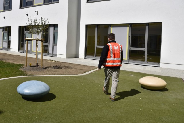 U.S. Army Corps of Engineers, Europe District Resident Engineer Will Adcock checks out the an outdoor garden feature area for students at the nearly completed Wiesbaden Elementary School project in the Hainerberg portion of U.S. Army Garrison...