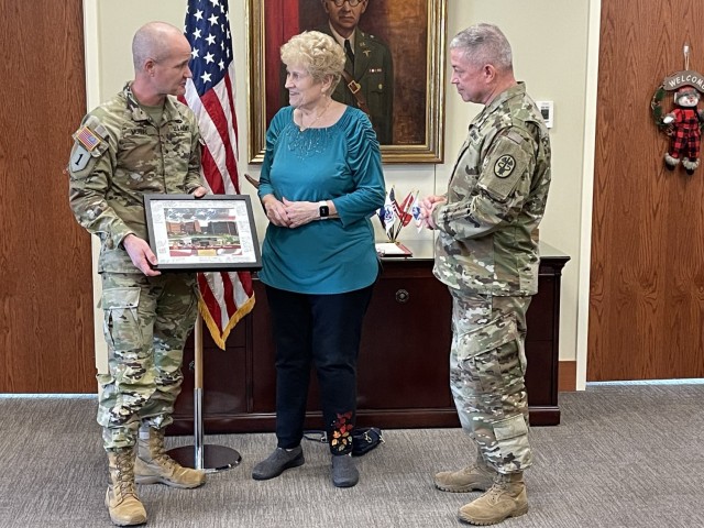 Brig. Gen. Clinton Murray, Brooke Army Medical Center commanding general, and Command Sgt. Maj. Thurman Reynolds, BAMC command sergeant major, present Inge Godfrey, BAMC’s Fisher House manager, a token of appreciation at BAMC, Fort Sam Houston, Texas, Dec. 10, 2021. Godfrey will retire at the end of 2021 with 29 years of service as BAMC’s Fisher House manager. (U.S. Army Photo by Elaine Sanchez)
