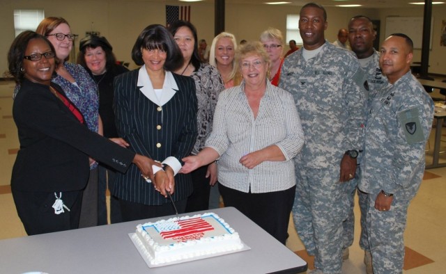 The 404th Army Field Support Brigade leadership and personnel gather to celebrate Women’s Equality Day at Joint Base Lewis McChord, Washington, Aug. 30, 2013. (Photo courtesy of U.S. Army)