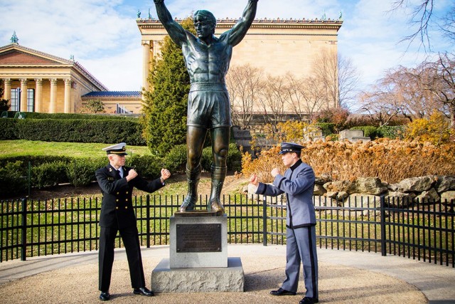 Class of 2023 Midshipman Jacob Lowe and Class of 2023 Cadet Josh Lowe pose for a photo in front of the Rocky Balboa statue in Philadelphia.   
						                        (Photo courtesy of Dave Lowe)