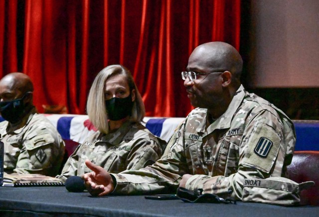 U.S. Army Medical Activity-Moncrief Army Health Clinic Command Sgt. Maj. Erin Hicks, left, and Command Sgt. Maj. Jermaine Lyons, 120th Adjutant General Battalion, right, speaks to noncommissioned officers during a professional leadership development panel Dec. 9, 2021 at the Post Theater on Fort Jackson, SC. During the panel, attendees were able to ask difficult questions to help them make informed decisions that could affect their future careers.
