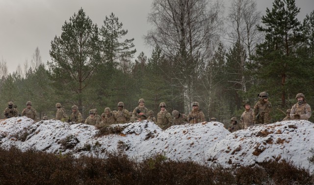 U.S. Army Soldiers with 1st Brigade Engineer Battalion &#34;Diehard,&#34; 1st Armored Brigade Combat Team, 1st Infantry Division, prepare to shield themselves from an explosion at Camp Ādaži, Ādaži, Latvia, Nov. 23, 2021. The Soldiers used Bangalore Torpedo charges to clear pathways through obstacles that would prevent them from advancing in a real war-time situation. 