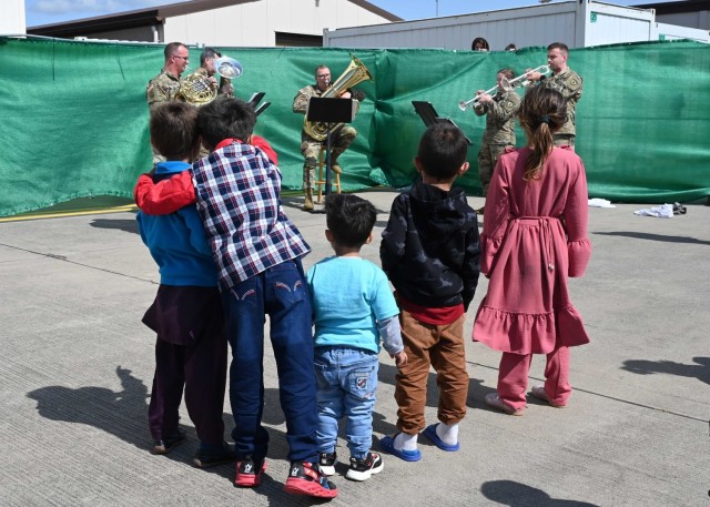 U.S. Army Soldiers with U.S. Army Europe and Africa Band and Chorus entertain Afghan evacuees at Ramstein Air Base, Germany, Aug. 24, 2021. The USAEUR-AF Band & Chorus supported Operations Allies Welcome by providing entertainment to the evacuees while they are in temporary lodging at Ramstein Air Base. 