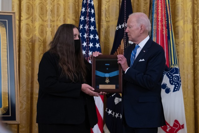 President Joe Biden presents the Medal of Honor to Tamara Cashe, widow of Sgt. 1st Class Alwyn Cashe, during a White House ceremony on Dec. 16, 2021. Cashe was posthumously awarded the Medal of Honor for actions of valor during Operation Iraqi Freedom while serving as a platoon sergeant with Alpha Company, 1st Battalion, 15th Infantry Regiment, 3rd Infantry Division, in Salah Ad Din province, Iraq, on Oct. 17, 2005.  (U.S. Army photo by Laura Buchta)