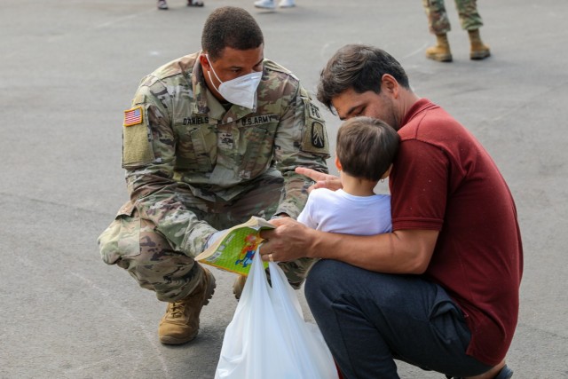 Soldiers from 21st Theater Sustainment Command provide security and assistance to Afghan evacuees at the transit area known as pod 51 on Ramstein Air Base September 9, 2021. The transit center provides a safe place for the evacuees to complete their paperwork while security screenings and background checks are conducted before they continue on to their final destination.