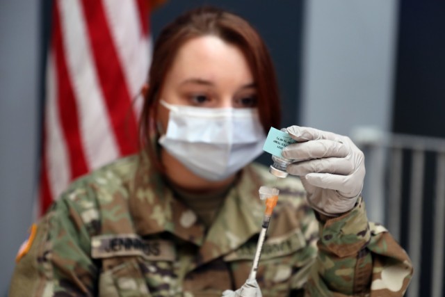 U.S. Army Pfc. Sara Jennings, a combat medic specialist assigned to Landstuhl Regional Medical Center, prepares doses of the Moderna COVID-19 vaccine.