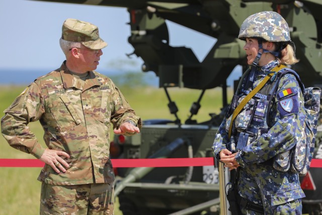 U.S. Army Brig. Gen. Gregory Brady (now Maj. Gen.), commander of the 10th Army Air and Missile Defense Command, speaks to a Romanian soldier in front of a static display during a field exercise, June 9, 2021. The static display was set up to show off weapon systems utilized during the exercise, which was part of Saber Guardian, an exercise with DEFENDER-Europe 21.

DEFENDER-Europe 21 is a large-scale U.S. Army-led exercise designed to build readiness and interoperability between the U.S., NATO allies and partner militaries. This year, more than 28,000 multinational forces from 26 nations will conduct nearly simultaneous operations across more than 30 training areas in 14 countries from the Baltics to the strategically important Balkans and Black Sea Region. 