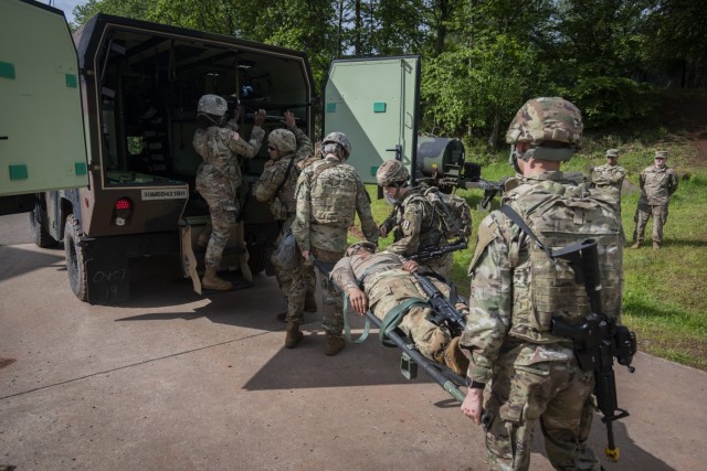 U.S. Soldiers with 30th Medical Brigade load a simulated casualty and K9 &#34;Diesel&#34; dog training puppet onto a military ambulance during Hospital Exercise 21 at Baumholder, Germany, June 3, 2021. The 30th MED BDE deployed over 400 Soldiers in support of Hospital Exercise 21 which served to certify the 519th Hospital center as a NATO role 2 enhanced capability. The 30th MED BDE treated over 100 simulated patients from the point of injury to medical evacuation to higher echelons of care. The exercise also enhanced joint, combine and multi echelon interoperability. 

DEFENDER-Europe 21 is a large-scale U.S. Army-led exercise designed to build readiness and interoperability between the U.S., NATO allies and partner militaries. This year, more than 28,000 multinational forces from 26 nations will conduct nearly simultaneous operations across more than 30 training areas in over a dozen countries from the Baltics to the strategically important Balkans and Black Sea Region. 