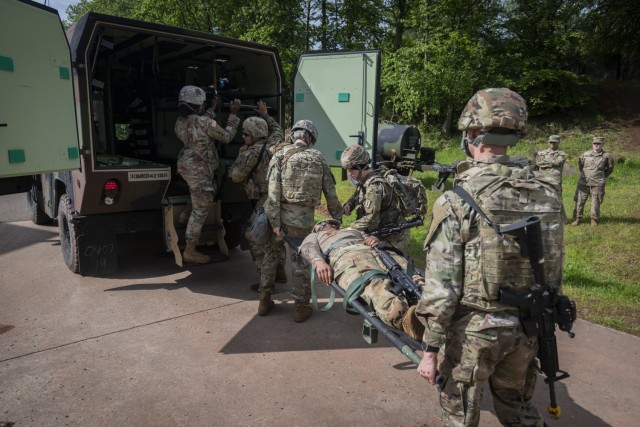 U.S. Soldiers with 30th Medical Brigade load a simulated casualty and K9 &#34;Diesel&#34; dog training puppet onto a military ambulance during Hospital Exercise 21 at Baumholder, Germany, June 3, 2021. The 30th MED BDE deployed over 400 Soldiers...