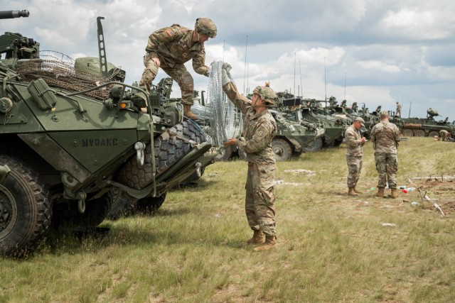U.S. Army Soldiers assigned to 2nd Cavalry Regiment move concertina wire on board a vehicle during Saber Guardian 21 at the Camp Ujmajor Training Area, May 30, 2021. Saber Guardian 21 is a DEFENDER-Europe 21 linked exercise, an annual large-scale U.S Army led, multinational, joint exercise designed to build readiness and interoperability between U.S., NATO, and partner militaries. 