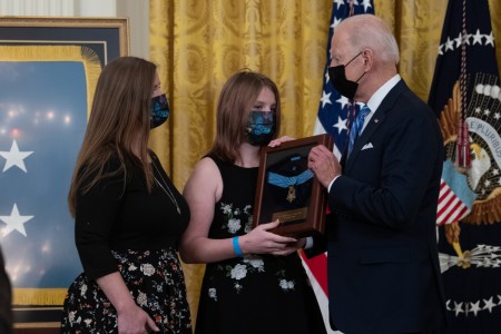 President Joseph R. Biden Jr. presents the Medal of Honor to Katherine Celiz, spouse of U.S. Army Sgt. 1st Class Christopher A. Celiz, and their daughter Shannon, during a ceremony at the White House in Washington, D.C., Dec. 16, 2021.  Sgt. 1st Class Celiz was posthumously awarded the Medal of Honor for actions of valor during Operation Freedom’s Sentinel while serving as a battalion mortar platoon sergeant with Company D, 1st Battalion, 75th Ranger Regiment, in Paktiya province, Afghanistan, on July 12, 2018. 