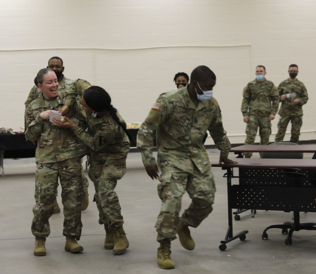 Religious Affairs Specialists from across III Corps and Fort Hood participate in a friendly competition discussing historical information, Fort Hood, Texas, Dec. 16, 2021. Soldiers had mini footballs they threw to signify they were ready to answer for their team. (U.S. Army photo by Sgt. 1st Class Angela Holtby)