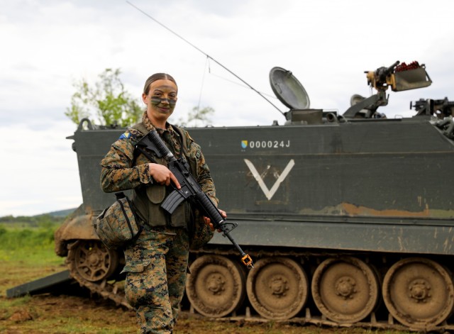 Sgt. Dzejlana Novalic, a grenadier assigned to 1st Infantry Company, 1st Infantry Battalion, 5th Infantry Brigade, Armed Forces of Bosnia and Herzegovina (AFBiH), pauses for a photo before conducting joint training for Immediate Response 21 at Manjača Training Area, Bosnia and Herzegovina (BiH), May 22, 2021. Immediate Response 21 is an exercise within DEFENDER-Europe 21 that provides the opportunity to train across all domains (air, sea, land, and cyber) in multiple countries and multiple exercises simultaneously. 