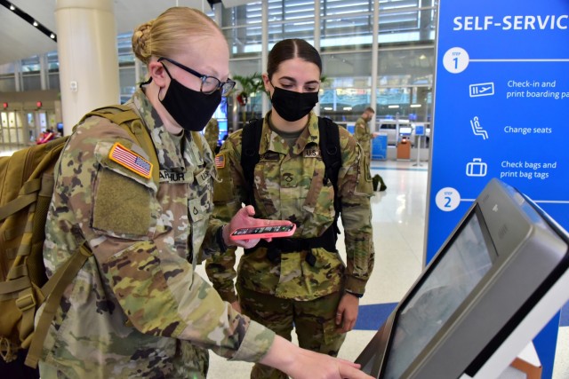 Two Soldiers check in at the San Antonio International Airport before their Holiday Block Leave.