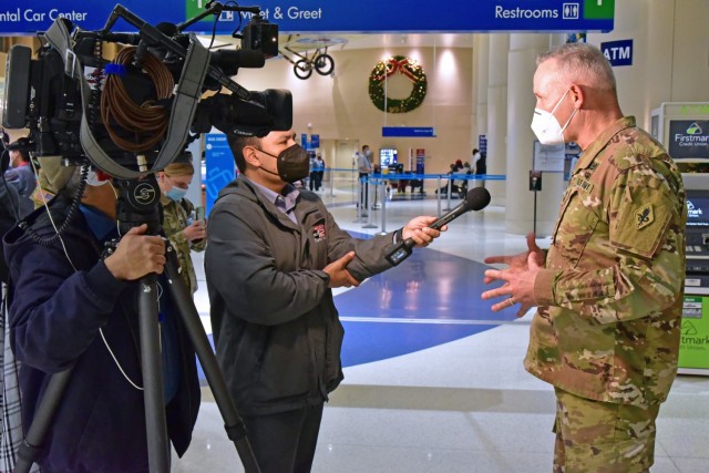 Maj. Gen. Dennis P. LeMaster, MEDCoE Commanding General, being interviewed by KSAT 12 News reporter RJ Marquez. San Antonio is known as Military City USA, and the departure of this many Soldiers along with Airmen, Sailors, and Marines on similar holiday travel, is of great interest to the local community. San Antonio City Council Members were at the airport greeting service members. Additionally local news media covered the event.
