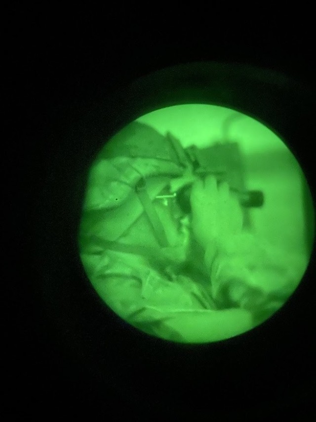 Spc. Xavier Villareal adjusts NVGs prior to driving a nighttime drivers course at Oberdachstetten Training Area, Germany, Dec. 16, 2021. (U.S. Army photo by Staff Sgt. Andrew Mangnall)