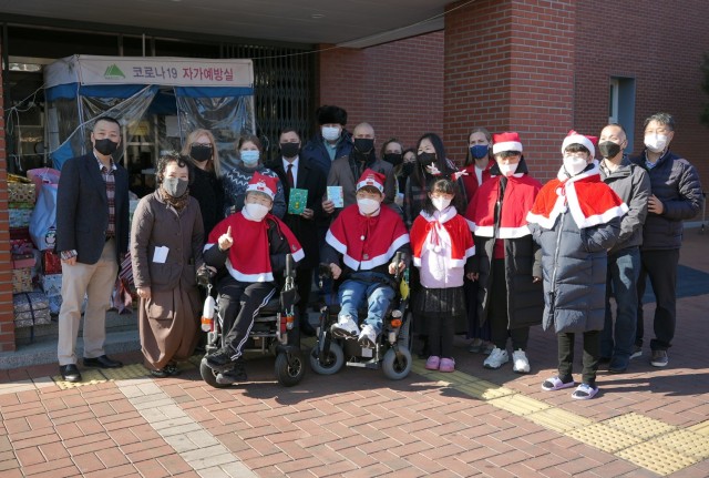 Members of the USAG Daegu community and staff and residents of the Love & Hope Orphanage pose for a group photo after exchanging gifts and cards. The event was part of a longstanding outreach program between U.S. Army Garrison Daegu and the orphanage, which dates back to 1952.