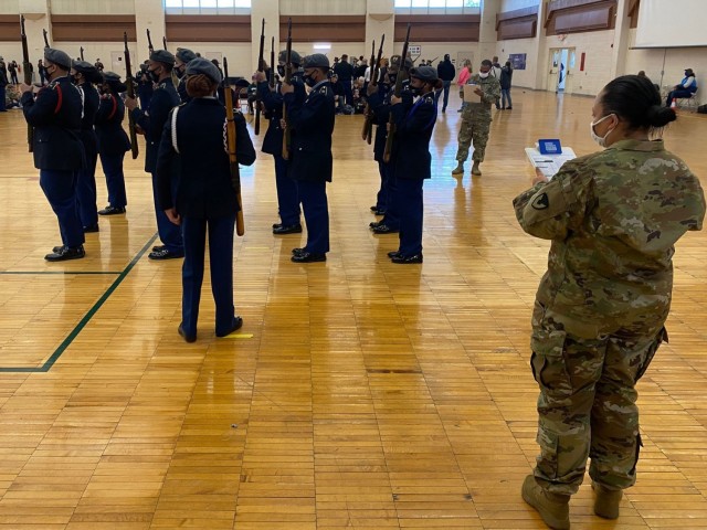 Sgt. 1st Class Lavonne Williams (right), U.S. Army Tank-automotive and Armaments Command’s Integrated Logistic Supports Center, evaluates JROTC cadets during the Michigan JROTC regional competition in Detroit, Dec. 11.
