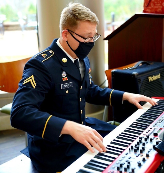 Fort Benning's Maneuver Center of Excellence Band member Cpl. Matt Twaddle plays the keyboard during Martin Army Community Hospital's holiday luncheon, December 16.