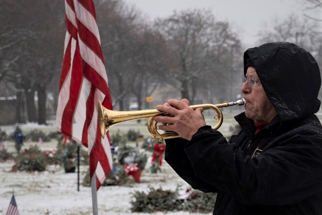 Bugler Richard McClelland (Lt. Col. Ret.) plays taps toward the conclusion of a Wreaths Across America ceremony held Dec. 18 in Clinton Township.