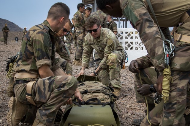 U.S. Army Staff Sgt. John Hampson, an instructor at the U.S. Army Mountain Warfare School, instructs French service members with the 5th Overseas Interarms Regiment (5e RIAOM) on casualty evacuation techniques at the French Combat Training Center at Arta Beach, Djibouti, Dec. 14, 2021. Five instructors from the U.S. Army Mountain Warfare School in Jericho, Vt. taught a five-day Joint Expeditionary Mountain Warfare Course on basic military mountaineering skills to French service members in Djibouti to strengthen the relationships among the international forces working together in the region.

(U.S. Army Photo by Staff Sgt. Amanda Stock)