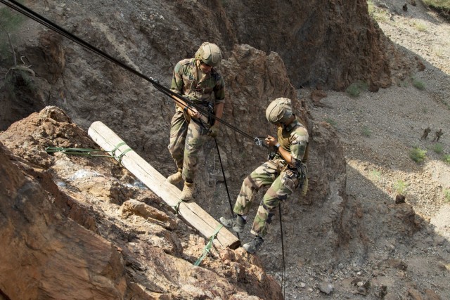 French service members with the 5th Overseas Interams Regiment (5e RIAOM) rappel down a mountain at the Arta Range Complex, Djibouti, Dec. 15, 2021. Five instructors from the U.S. Army Mountain Warfare School in Jericho, Vt. taught a five-day Joint Expeditionary Mountain Warfare Course on basic military mountaineering skills to French service members in Djibouti to strengthen the relationships among the international forces working together in the region.

(U.S. Army Photos by Staff Sgt. Amanda Stock)