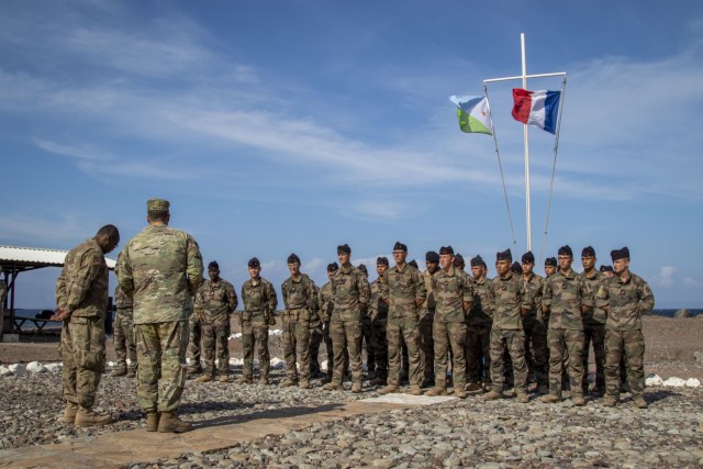 U.S. Army Lt. Col. Frank Tantillo, Commander, Task Force Iron Gray, speaks about the importance of joint training during the graduation ceremony of the Joint Expeditionary Mountain Warfare Course at the French Combat Training Center at Arta Beach, Djibouti, Dec. 16, 2021. Five instructors from the U.S. Army Mountain Warfare School in Jericho, Vt. taught a five-day Joint Expeditionary Mountain Warfare Course on basic military mountaineering skills to French service members in Djibouti to strengthen the relationships among the international forces working together in the region.

(U.S. Army Photo by Staff Sgt. Amanda Stock)