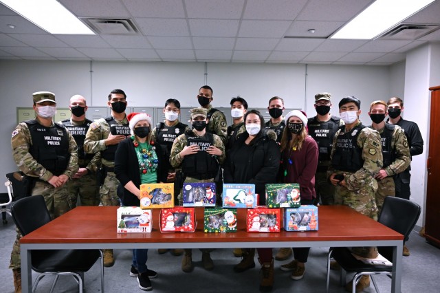 Volunteers deliver cookies to the Camp Humphreys military police at the Department of Emergency Services Dec. 20, 2021. (U.S. Army photo by Monica K. Guthrie)