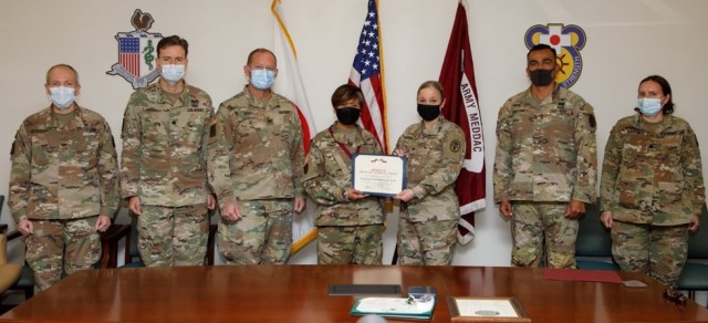 Lt. Col. Dolores &#39;Dolly&#39; Toney, center left, a nurse practitioner who is deputy commander for nursing at U.S. Medical Department Activity-Japan, is inducted into the Order of Military Medical Merit by Col. Tanya Peacock, center right, commander, MEDDAC-Japan, on Dec. 14.