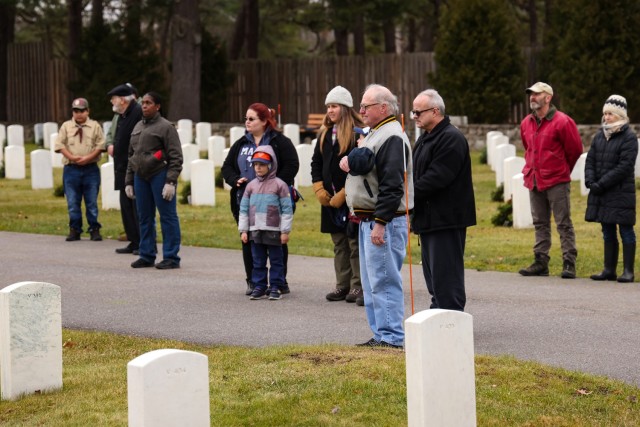 Volunteers bow their heads in prayer at the Wreaths Across America ceremony.
