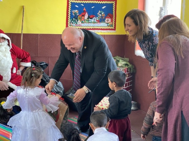 James Adamski, Deputy Garrison Manager of Novo Selo Training Area, Bulgaria, gives gifts to children of a local school, December 22, 2021. Novo Selo Training Area personnel were invited to local schools to share and exchange holiday traditions, and learn about local culture. 