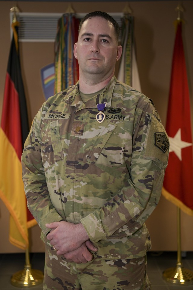 U.S. Army Maj. Robert Morse, chief of theatre operations for Regional Cyber Center-Europe, U.S. Army Cyber Command, wears the Purple Heart award on his left jacket lapel after being presented with it during a small ceremony at the Lt. Gen....