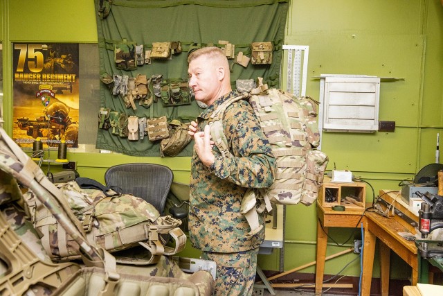 Maj. Gen. Julius &#34;Dale&#34; Alford, commanding general of U.S. Marine Corps Training Command, tries on a ruck sack prototype in the Load Carriage Lab during a visit by U.S. Marine Corps personnel to the U.S. Army Combat Capabilities Development Command (DEVCOM) Soldier Center on December 8, 2021 in Natick, MA.